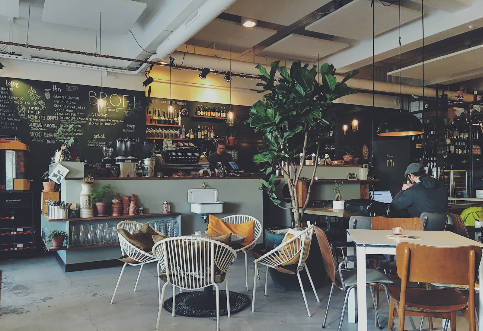 Café counter with a barista preparing coffee