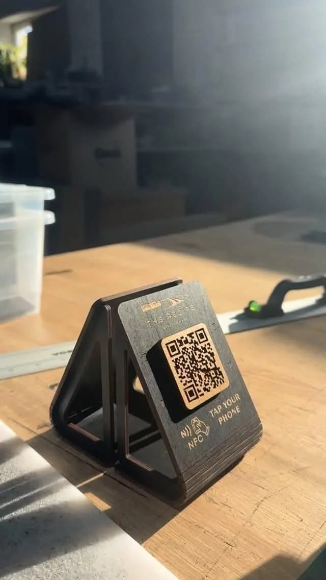 Laser-cut wooden NFC tent with tap-your-phone mark